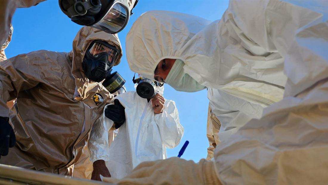 Certified mold remediation technicians in protective suits and respirators working inside containment in Gettysburg PA